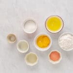 ingredients for strawberry cake in individual bowls.