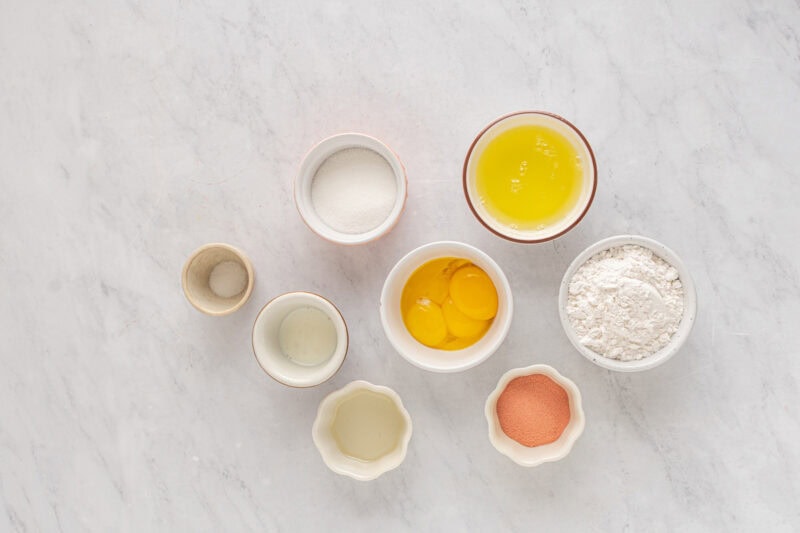ingredients for strawberry cake in individual bowls.