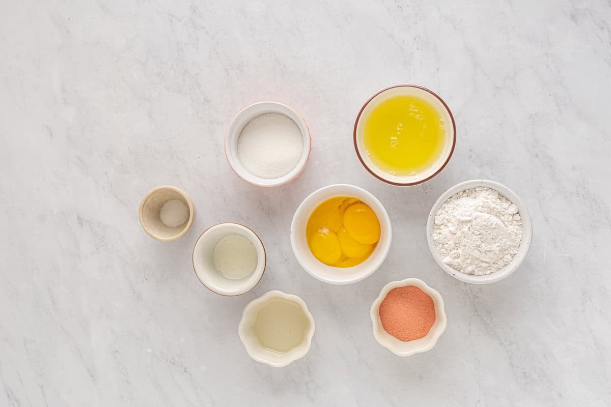 ingredients for strawberry cake in individual bowls.