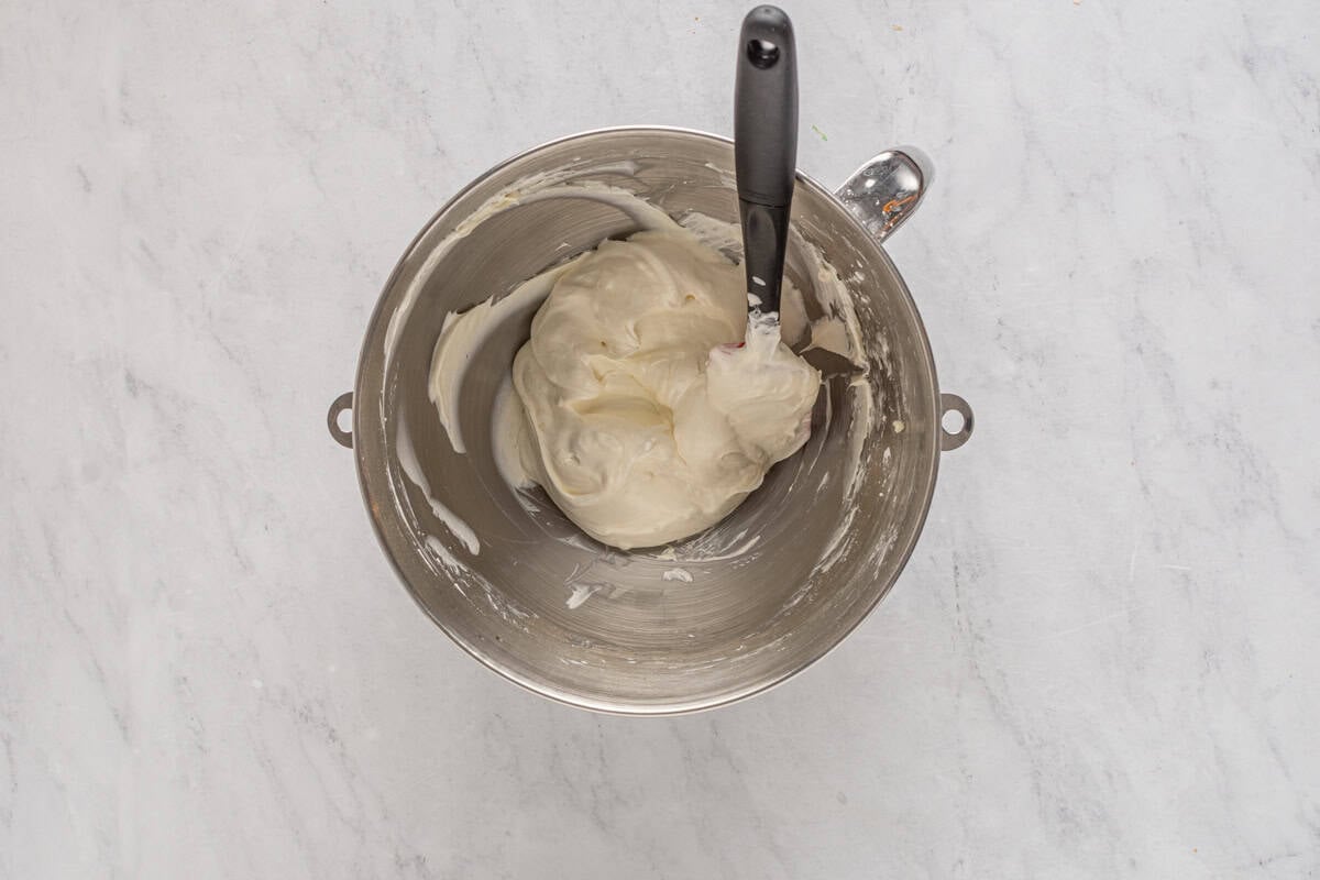 folding cool whip into beaten cream cheese with a rubber spatula.