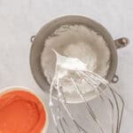 whipped meringue on a stand mixer whisk.