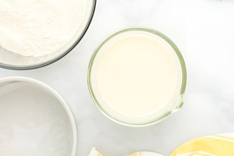 wet ingredients for lemon cake in a glass bowl.