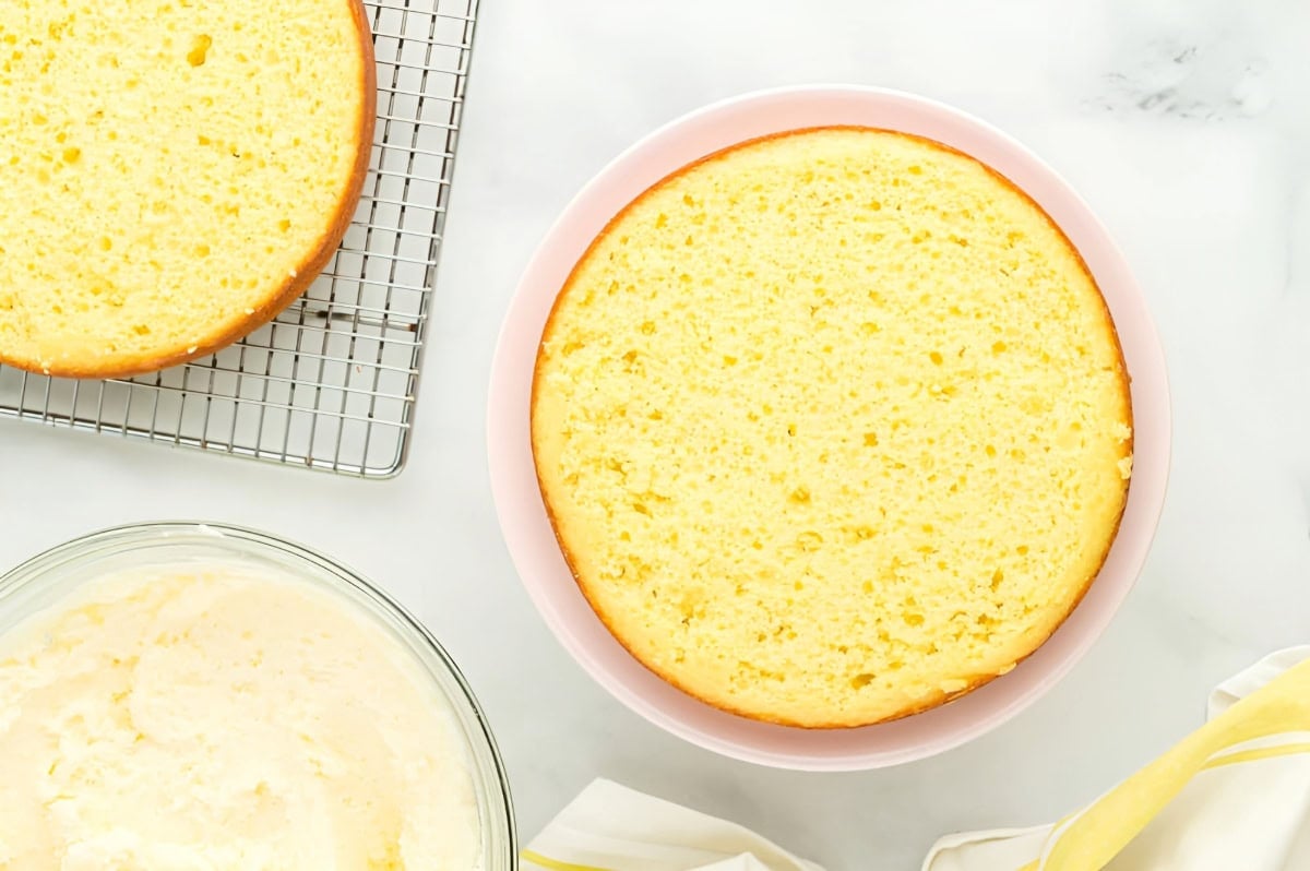 leveled lemon cake layer on a cake stand.