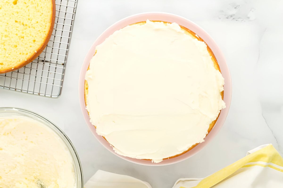 a layer of moist lemon cake topped with lemon buttercream.