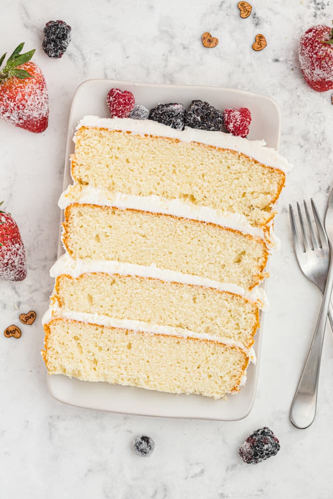 overhead view of a slice of naked cake on a plate.