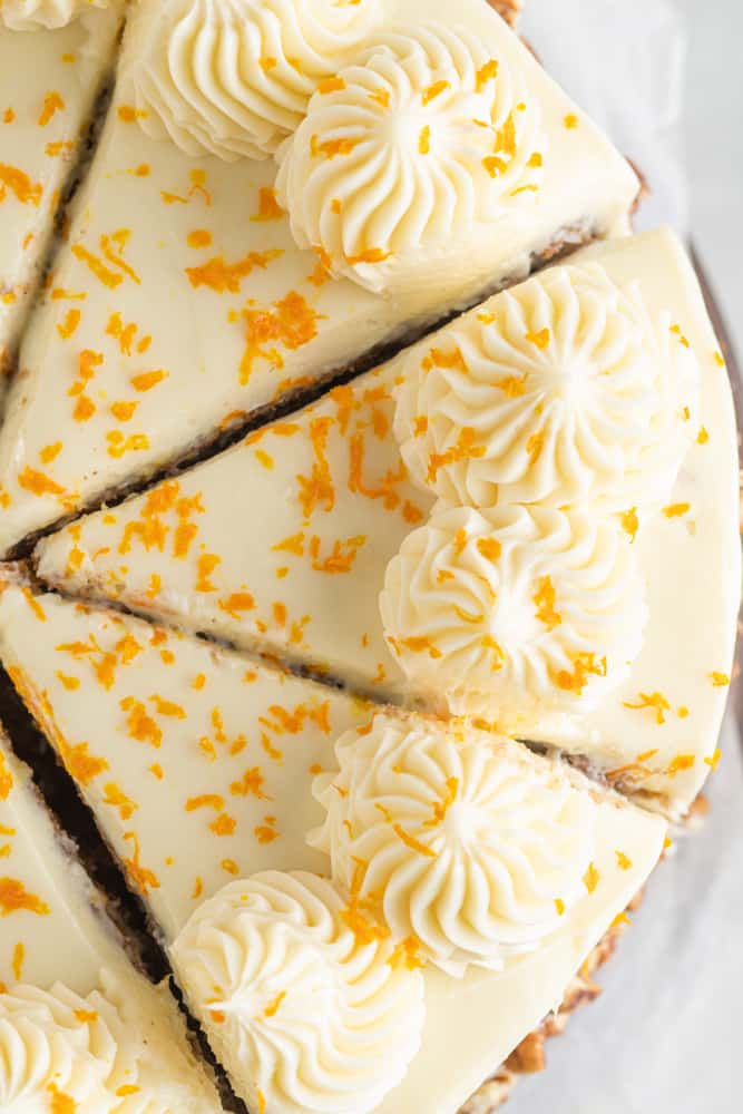 close up on the top of the cake, cut into slices and garnished with orange zest