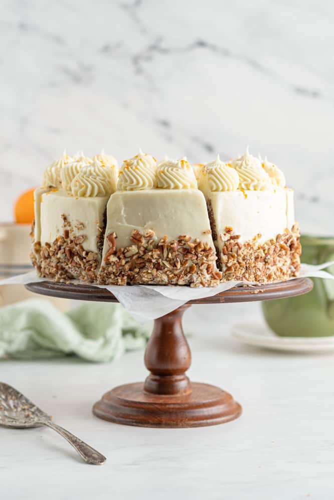 carrot cake with cream cheese frosting on a cake stand