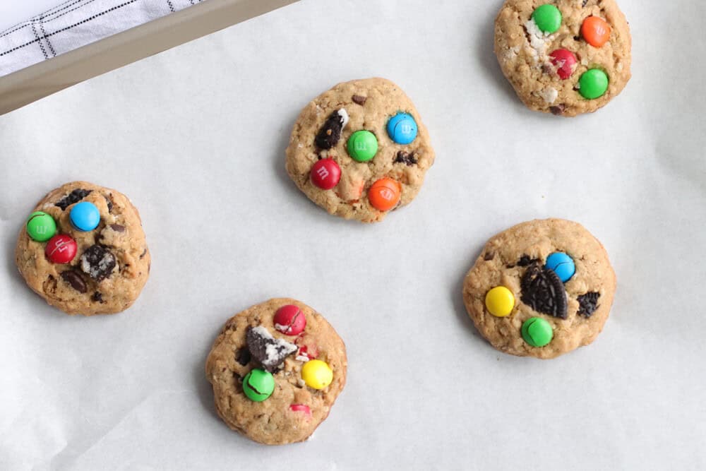 oreo monster cookies on a parchment lined baking tray