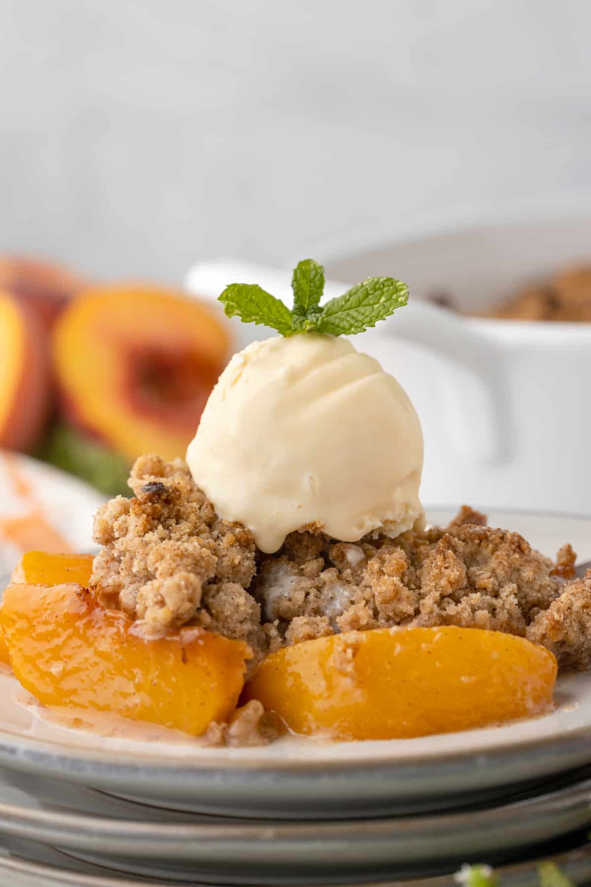 peach cobbler topped with a scoop of vanilla ice cream