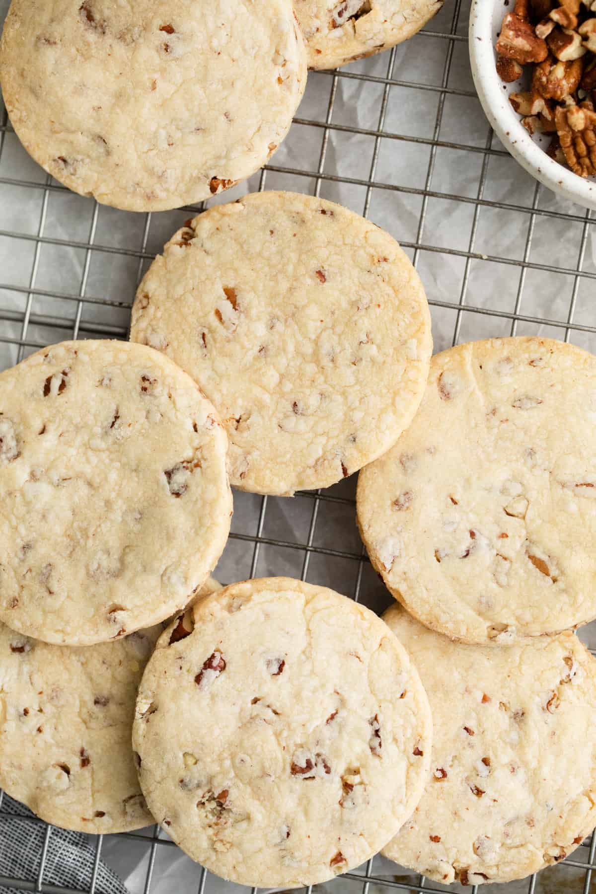 a group of cookies on a wire rack.