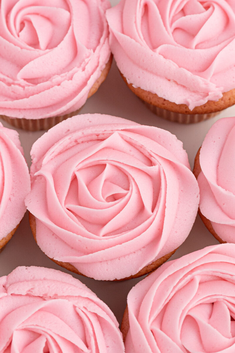 overhead view of moscato cupcakes piped with pink buttercream roses.