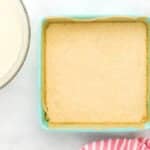 baked shortbread cookie crust in a lined square baking pan.