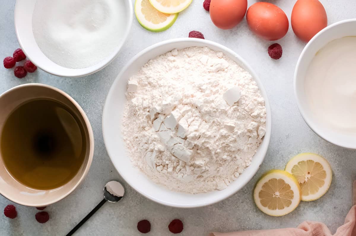 ingredients for raspberry olive oil cake in separate bowls.