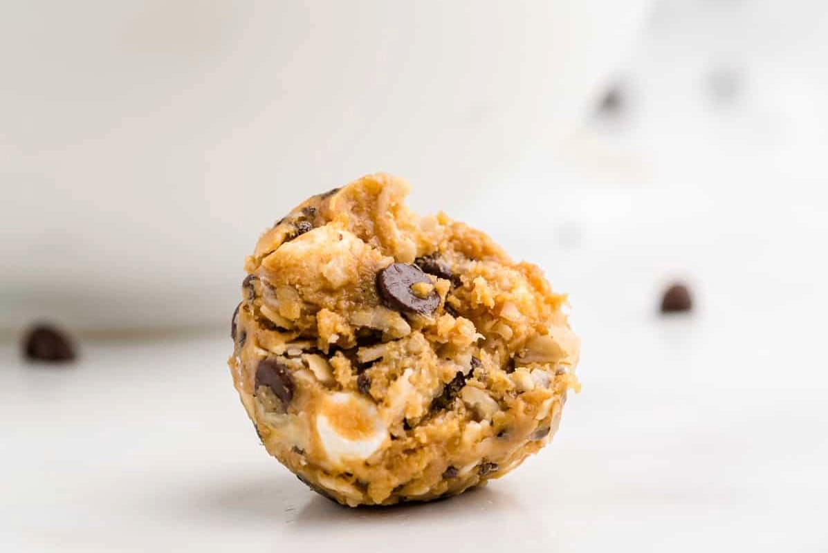 a bitten s'mores energy ball on a table.
