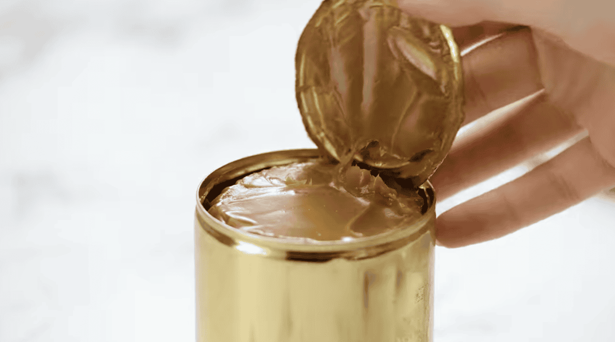 opening a sealed can of dulce de leche.