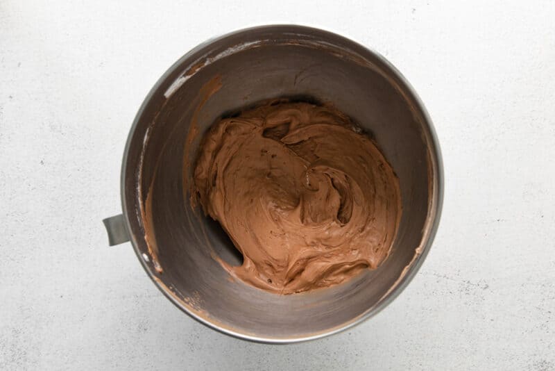 no bake chocolate cheesecake batter in a stainless mixing bowl.