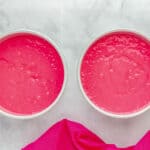 pink velvet cake batter in 2 round cake pans.