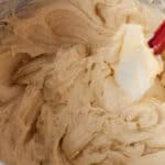 almond blondie dough in a stand mixer bowl with a rubber spatula.