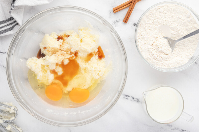 a bowl with eggs, flour, sugar and cinnamon.