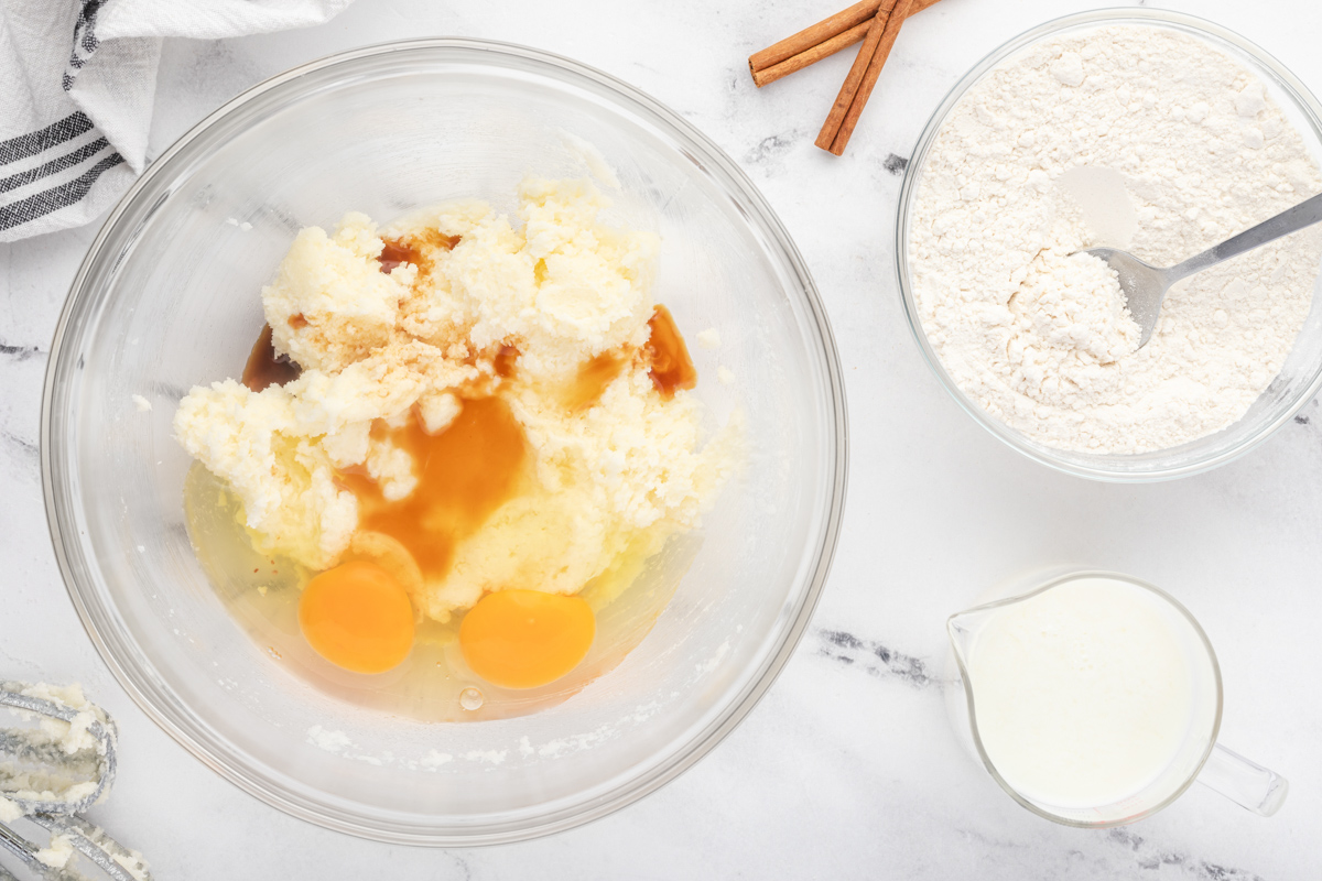 a bowl with eggs, flour, sugar and cinnamon.
