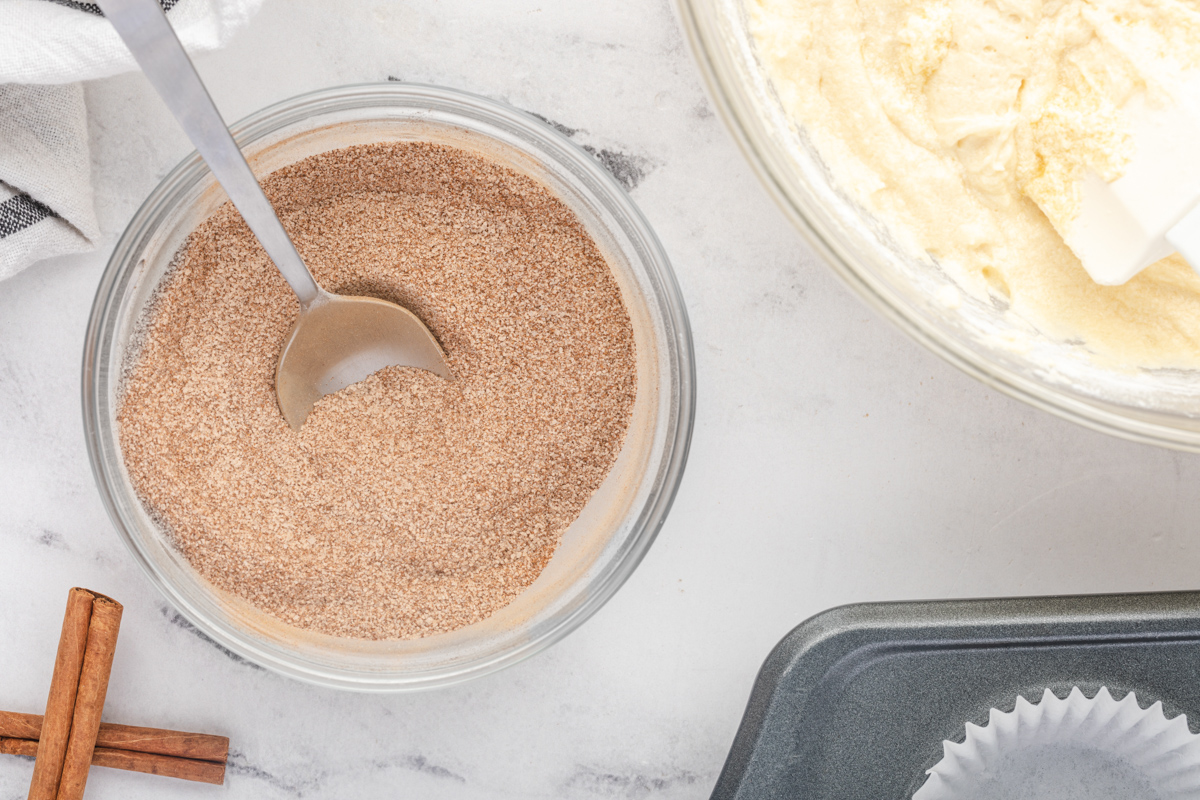 cinnamon and sugar in a bowl with a spoon.