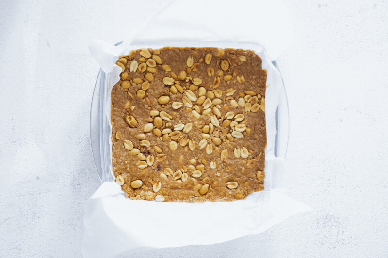 a baking dish filled with peanut butter and nuts.
