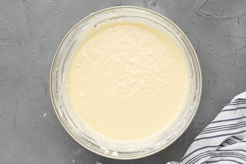 cake batter in a glass bowl on a gray background.