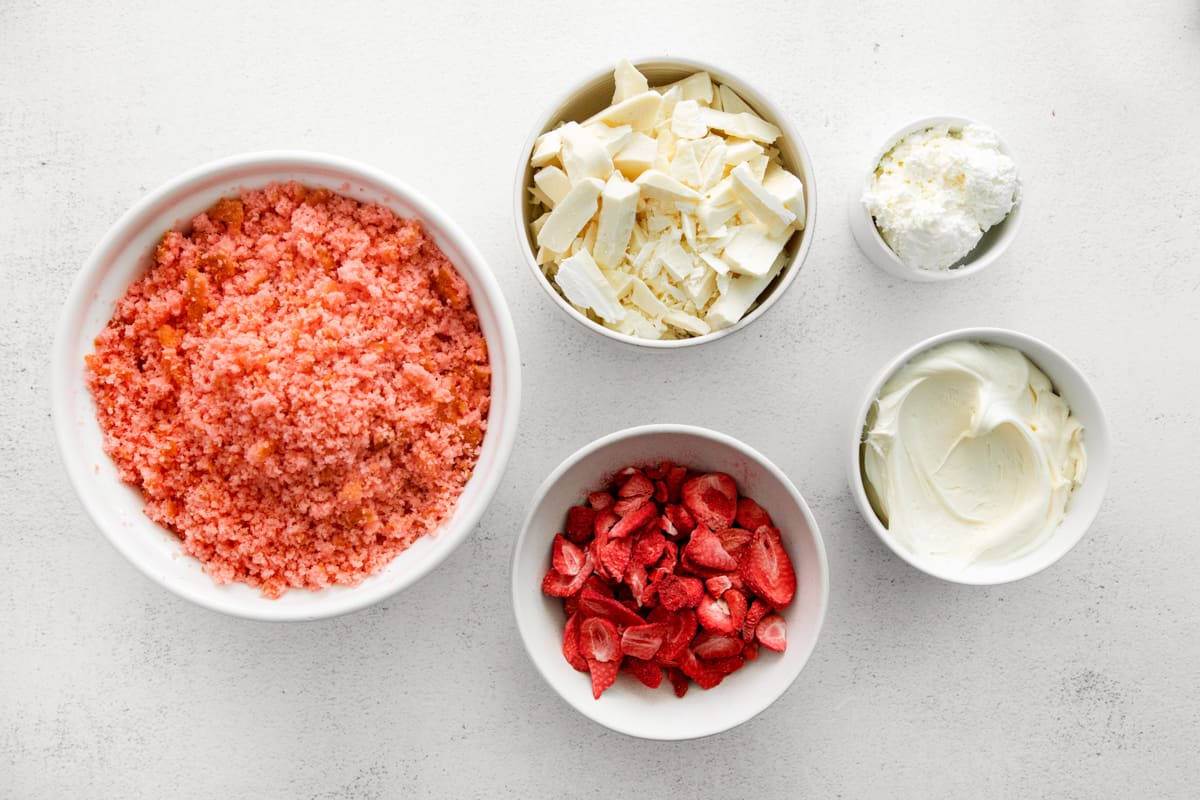 overhead view of ingredients for white chocolate strawberry cake mix truffles in individual bowls.