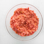 crumbled strawberry cake in a glass bowl.
