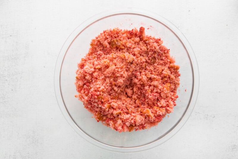 crumbled strawberry cake in a glass bowl.
