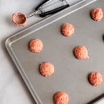 strawberry cookie dough balls on a baking sheet.