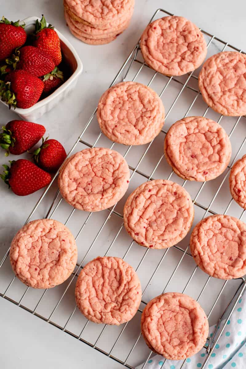 baked strawberry cookies on a wire rack.