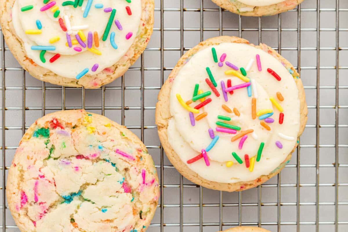 overhead view of 3 birthday cookies on a wire cooling rack.