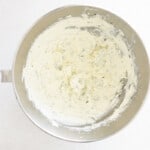 beaten cream cheese in a stainless mixing bowl.