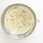 flavored cream cheese in a stainless mixing bowl.