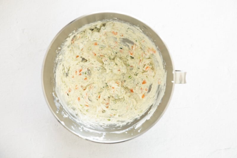 flavored cream cheese in a stainless mixing bowl.