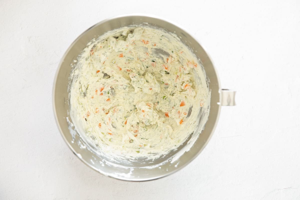 Veggie cream cheese in the bowl of a stand mixer.