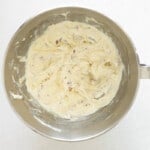 flavored cream cheese in a stainless mixing bowl.