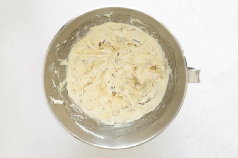 flavored cream cheese in a stainless mixing bowl.