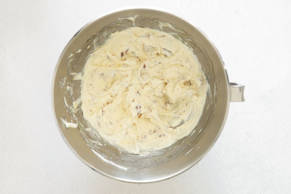 Honey pecan cream cheese in the bowl of a stand mixer.