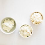 3 bowls, each with a different flavor of cream cheese in them.