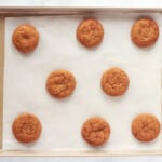 8 baked gingersnap cookies on a baking sheet.