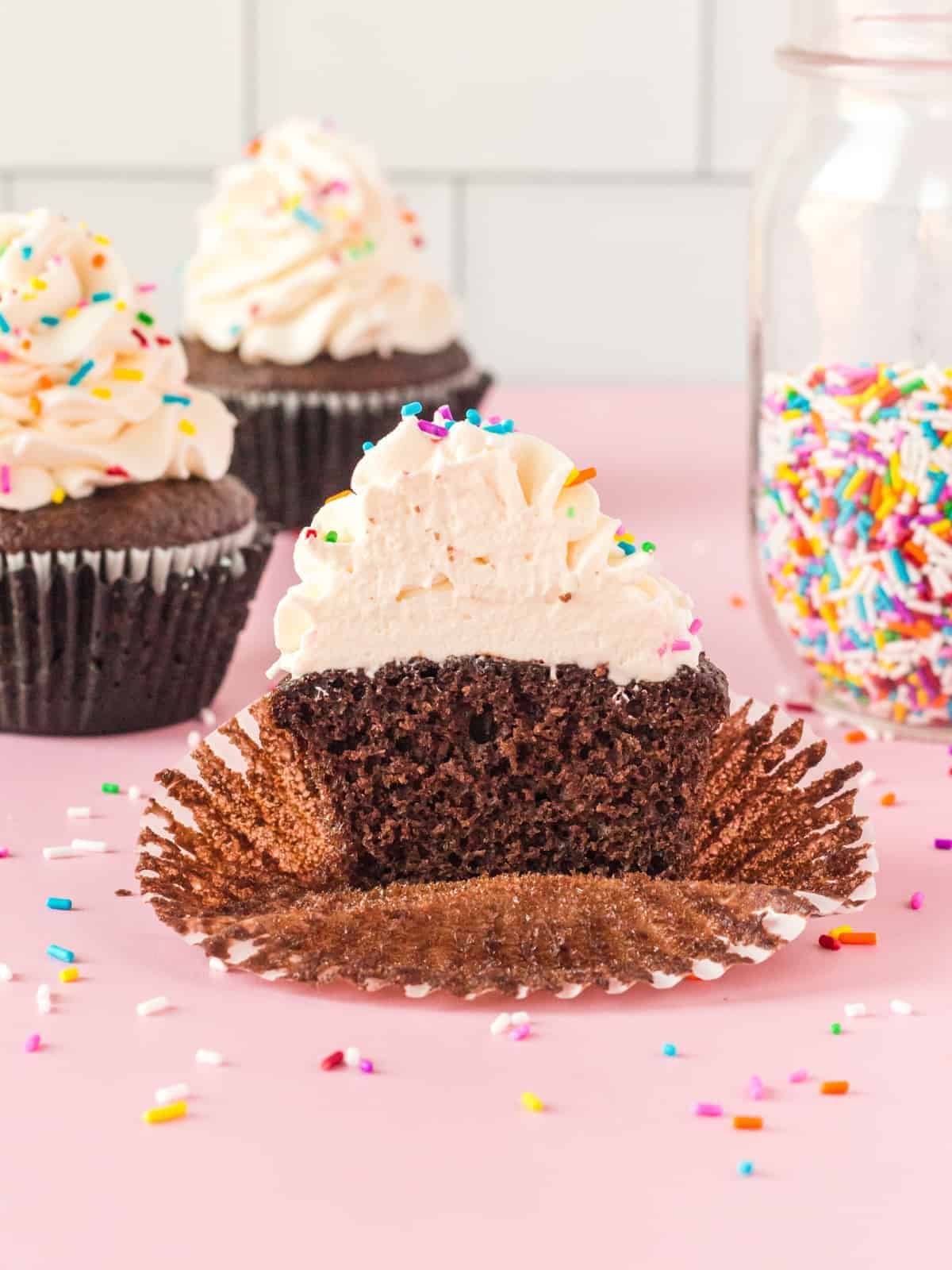 cupcake topped with stabilized whipped cream cut in half
