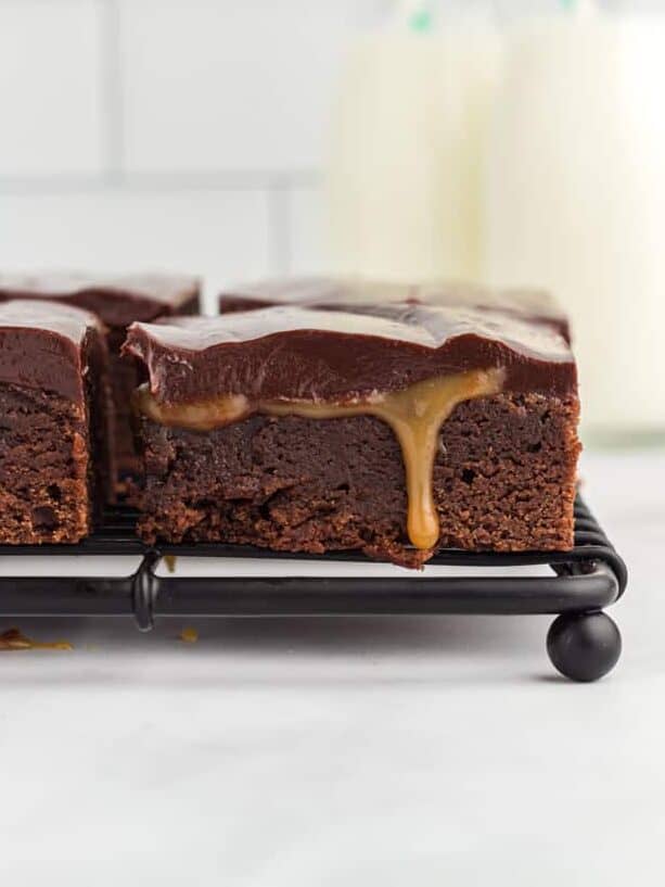 side view of caramel brownies on a wire rack.
