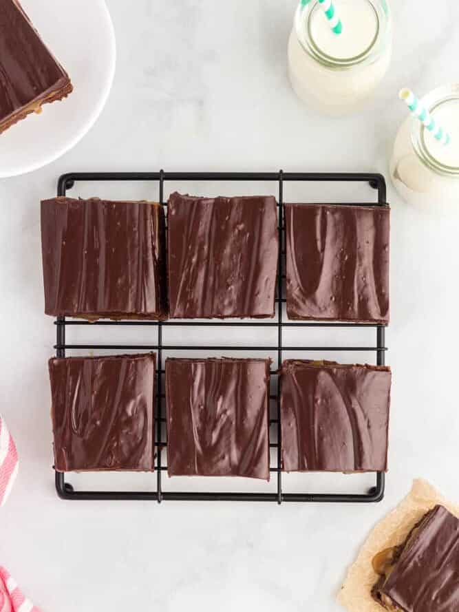 overhead view of 6 caramel brownies on a wire rack.
