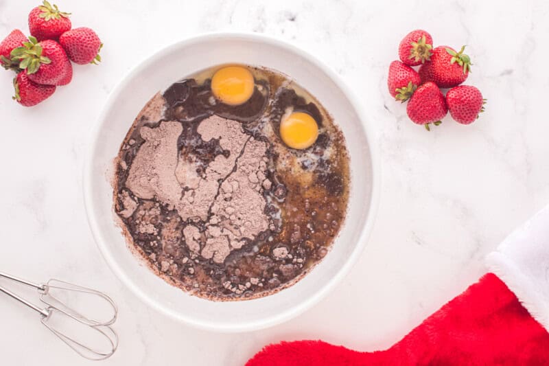 brownie batter ingredients in a mixing bowl, unmixed.