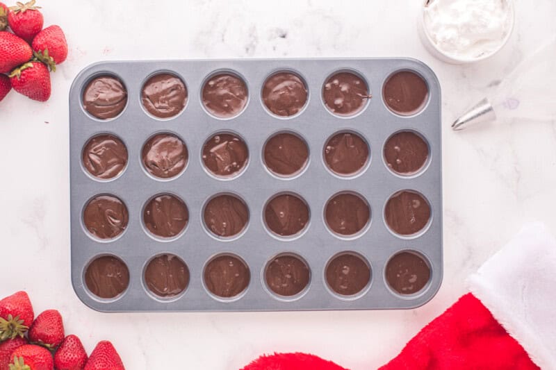 mini cupcake tin filled with brownie batter.