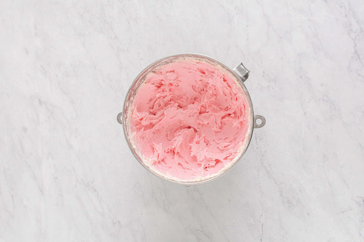 pink frosting in a mixing bowl.