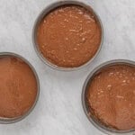 three metal pans filled with chocolate batter.