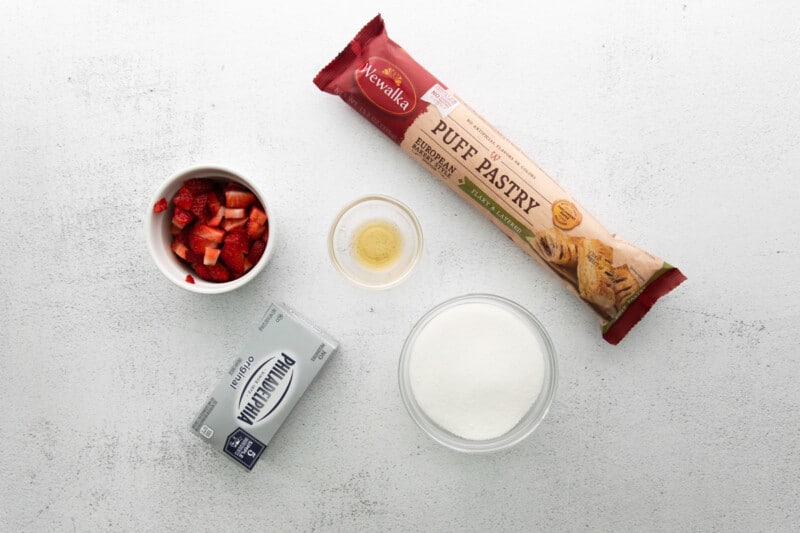 the ingredients for strawberry granola bars are shown on a white surface.